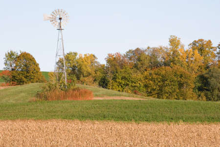 Windmill atop a field in the autumn monthsの写真素材