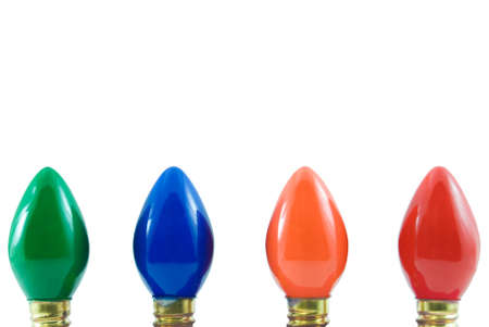 Four different colored Christmas lights isolated on whiteの写真素材