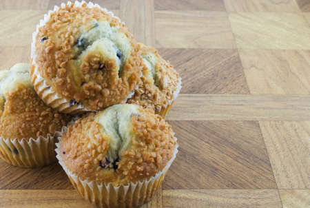 Several blueberry muffins on a wooden textureの写真素材