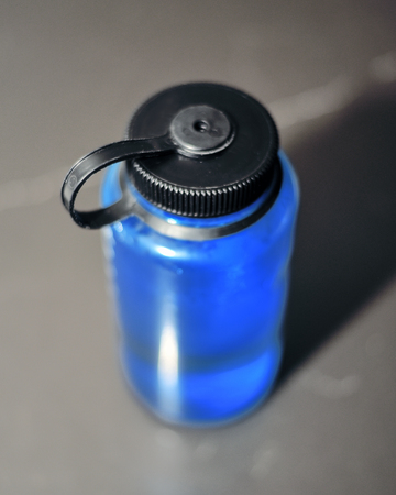 Blue water bottle with screw-on lidの写真素材