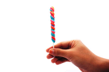 Hand holding a small candy lollipopの写真素材