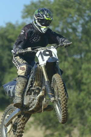 ZAMBERK, CZECH REPUBLIC - JULY 09. An unidentified motocross riders jumping in the Eastern Bohemia Cup motocross race on July 09, 2011 in Zamberk, Czech Republic.(dark background) のeditorial素材