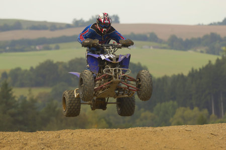 MOHELNICE, CZECH REPUBLIC - SEPTEMBER 17. Unidentified racer jump with a quad motorbike in the Czech...