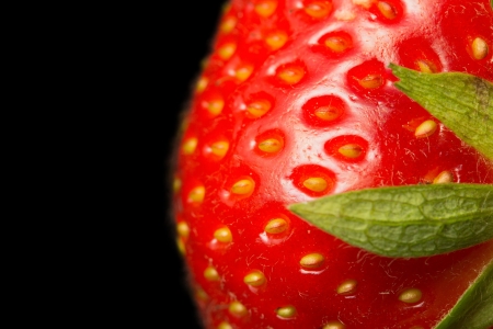 Macro view of fresh strawberry on a black background  Strawberry is in the right half of the photos の写真素材