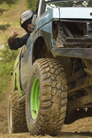 MOHELNICE, CZECH REPUBLIC - JUNE 10. Unidentified passenger at off-road car on a steep slope in the...