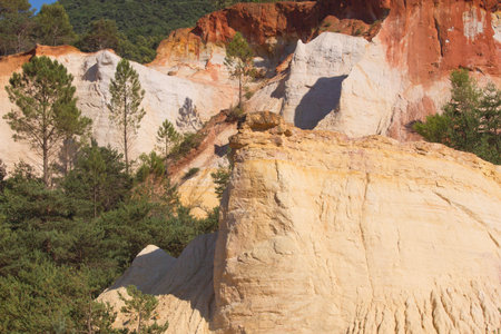 White and red ocher hills and blue sky in the background  Ocher rocks  French Colorado  near Rustrel...