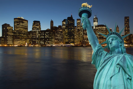 Lower Manhattan in the night with doseup of Statue of Liberty  New York City, USA 