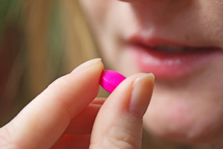 Detailed view of young woman with pill 