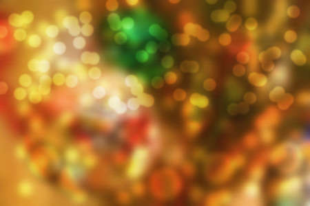 Yellow and orangre abstract Christmas background blurry bokeh. The picture has highlighted the texture of canvasの写真素材
