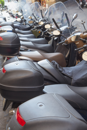 Scooters parked in a row are the most popular means of transport in the Mediterranean. All potential trademarks are removed.のeditorial素材
