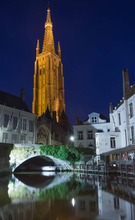 Dijver canal and tower of the Church of Our Lady at night (Bruges, Belgium)のeditorial素材