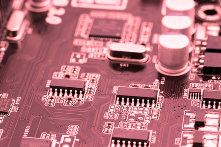 Close up background of computer motherboard in red color. All potential trademarks are removed.の写真素材