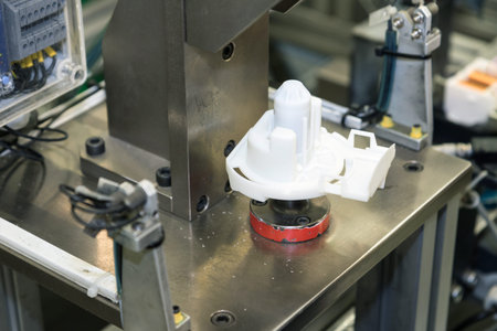 Assembly line of plastic components. Closeup view of the work table with plastic component.