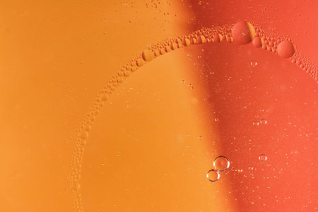 Abstract of oil drops on water. Everything is on the red and yellow background.