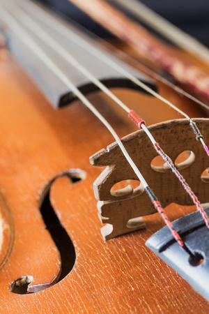 Closeup view of the used old violin. Edited as a vintage photo.  All potential trademarks are removed.の写真素材