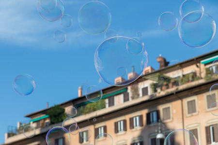 Colorful soap bubbles are flying over buildings on Navona Square in Rome. Italy.の写真素材