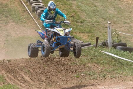 BREZOVA NAD SVITAVOU, CZECH REPUBLIC - JUNE 15, 2019: Quad rider in blue jumping in the race International Championship of Czech Republic in Quad 2019 in area Brezovske strane in Brezova.のeditorial素材