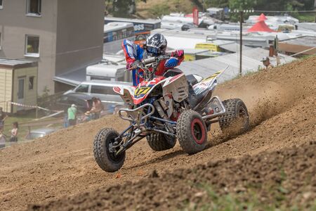 BREZOVA NAD SVITAVOU, CZECH REPUBLIC - JUNE 15, 2019: Young quad rider skidding a curve in International Championship of Czech Republic in Quad 2019 in area Brezovske strane, Brezova.のeditorial素材