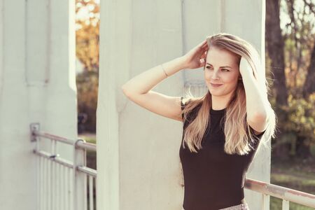 Attractvive girl comb her long hair by hands looking at the side.  Edited as a vintage photo.の写真素材