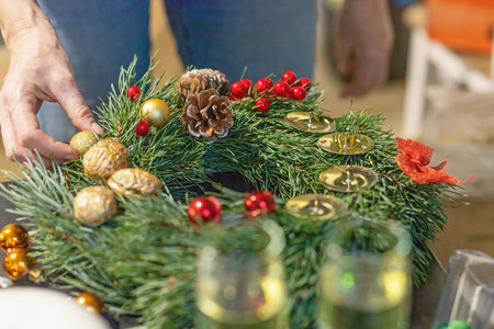 Woman completes a handmade advent wreath. Christmas workshop. Horizontally.の写真素材