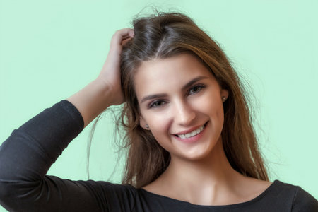 Portrait of smiling beautiful girl on the green background. Horizontally.の写真素材