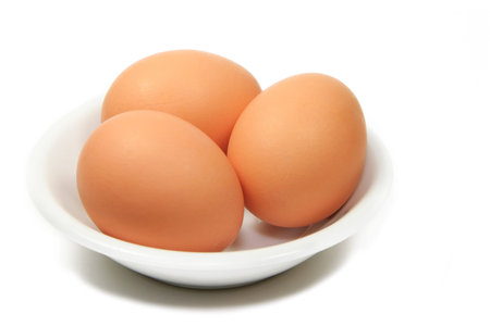 Three Brown Eggs in a Small Dish