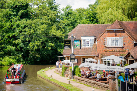 Wisley, Surrey, UK - June 2014: Narrowboat passes The Anchor pub のeditorial素材