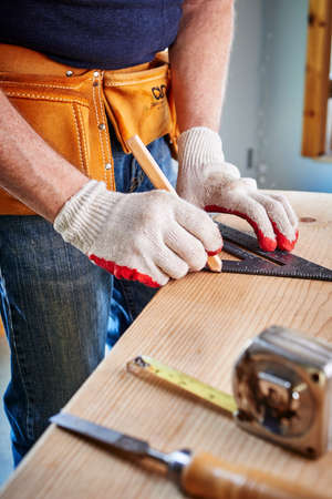 a carpenter making a measurementの写真素材