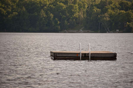 A swimming platform anchored in a lake.の写真素材