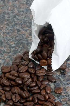 Picture of coffee beans rolling out of a bagの写真素材