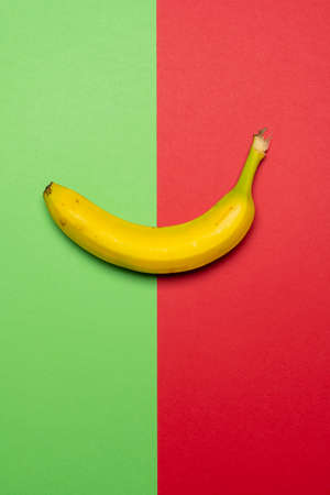 Still life stock photo of ripe yellow banana on coloured backgroundの写真素材