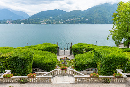 View over the beautiful Como lake, seen from the museum and botanical garden of Villa Carlotta. View is from the terrace at the villa, over the garden, lake and towards the town of Bellagio.のeditorial素材