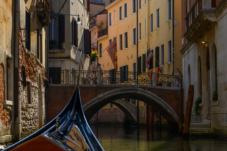 Venice canals, Venice, Veneto, Italy. July 25, 2022. Editorial stock picture of canals, houses, buildings and bridges, seen from a gondola sailing in the canals of the beautiful city of Venice, Italy. It is a beautiful sunny summer day.の写真素材