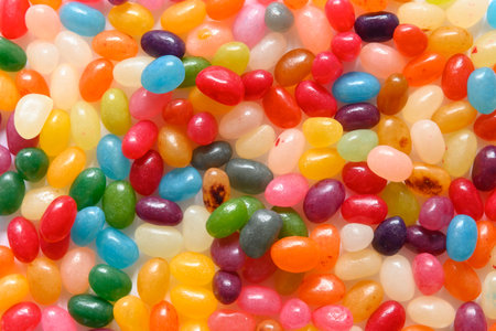 Close up of pile of very colorful jellybean sweets, filling out the full picture. Delicious looking candy in strong, saturated colors.の写真素材