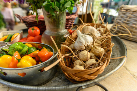 Very rustic sales stall with tomatoes, apples, peppers, and flowers. Big tray at a farm shop with fresh, organic fruit and vegetablesの写真素材