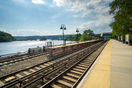 Bronx, NY / USA - 8/1/2020: A landscape view of the MetroNorth Spuyten Duyvil Train Station and the...