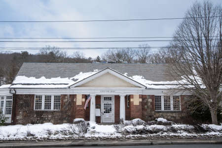 Tuxedo Park, NY - USA - Feb. 20, 2021: A winter view of the historic Tuxedo Park Library, built in the center of Town in 1901 by Bruce Price.のeditorial素材
