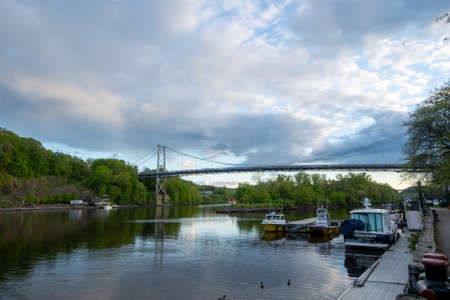 Kingston, NY - USA- May 12, 2021: a landscape view of the Wurts Street Bridge or the The KingstonâPort Ewen Suspension Bridge, is a steel suspension bridge spanning Rondout Creek.のeditorial素材