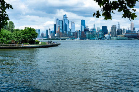 Hoboken, NJ - USA - July 18, 2021: horizontal view of the Hoboken's Pier C Park and crossed the Hudson River, Manhattan's westside Hudson Yards.のeditorial素材