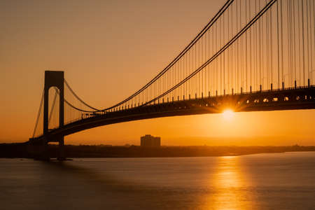 Staten Island, NY - USA - Sept. 18th 2021: A landscape view of the Verrazzano-Narrows Bridge,seen from Fort Wadsworth in the Gateway National Recreation Area during the golden hour.のeditorial素材