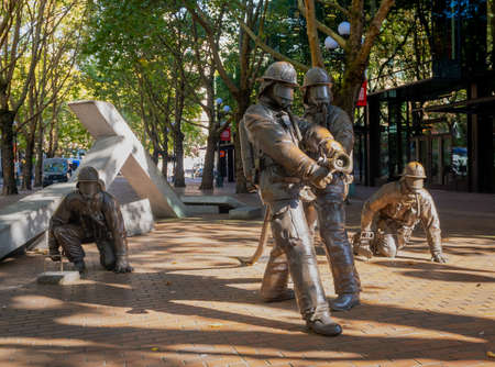 Seattle, WA - USA - Sept. 23, 2021: Horizontal view of the Memorial To Fallen Firefighters in in Occidental Park, Seattle. Fallen Firefighters Memorial is a bronze sculpture group by Hai Ying Wu.のeditorial素材