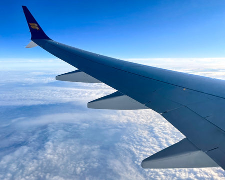 Keflavik, Iceland - July 1, 2022 Landscape view of the port side wing of an  Icelandairâs Boeing 737MAX 9 Passenger jet preparing to land at Leifur Eiriksson Air Terminal.のeditorial素材