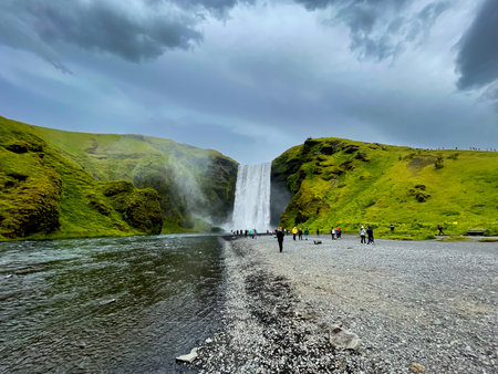 SkÃ³gar, Iceland - July 3, 2022 A wide angle view of SkÃ³gafoss, a waterfall on the SkÃ³gÃ¡ River in the south of Iceland at the cliff marking the former coastline.のeditorial素材
