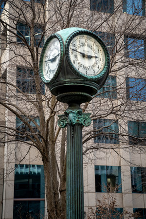 Hartford, CT - USA - Dec 28, 2022 Vertical image of an antique street clock bearing the name Hartford National Bank and Trust Company rises from the sidewalk in downtown Hartford.のeditorial素材