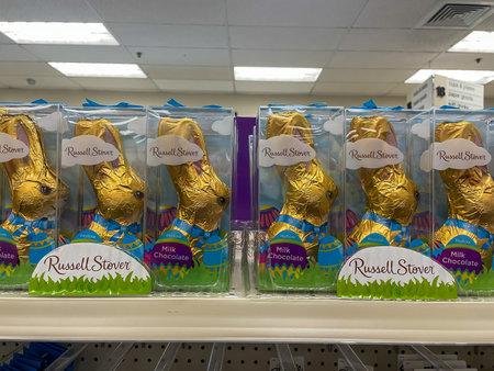 Suffern, NY - USA - Feb 4, 2023 Landscape closeup image of Russell Stover Hollow Milk Chocolate Bunnies in decorative packaging, lined up on a drugstore shelf for the Easter Holiday.のeditorial素材