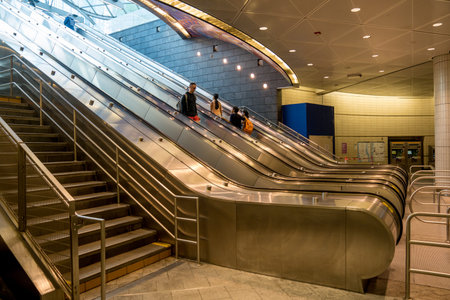 New York, NY - USA - April 14, 2023 View of commuters riding escalators to the entrance to the 34...