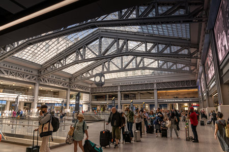New York, NY - USA - April 14, 2023 Horizontal view of people lined up for a train at the Moynihan Train Hall, an expansion of Pennsylvania Station, the main intercity and commuter rail station in NYCのeditorial素材