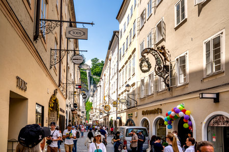 Salzburg, AT â June 7, 2023 View of the Getreidegasse, in bustling heart of Salzburg's Old Town. Charming street lined with shops and cafes.のeditorial素材
