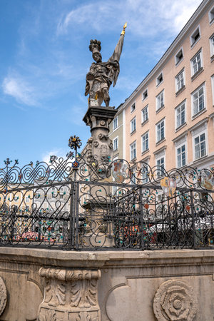 Salzburg, AT â June 7, 2023 View of the Florianibrunnen, a Baroque fountain on the old market of the Old Town of Salzburg. The fountain features a central pillar with a sculpture of St. Florian.のeditorial素材