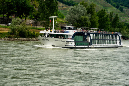 Wachau, Lower Austria â AT â June 8, 2023 Landscape view of the Monarch Empress, a deluxe river cruise vessel operated by Gate 1 Travel, cruising down the Danube River.のeditorial素材